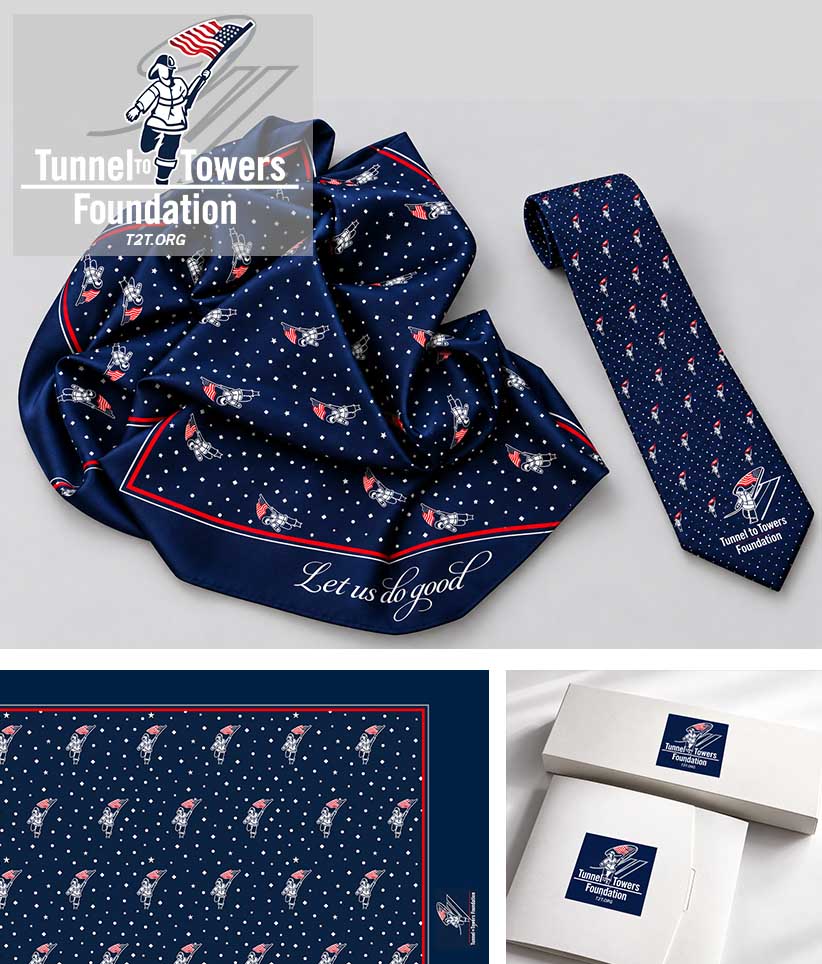 A navy blue necktie and matching scarf set with a repeating fireman pattern, shown on a light gray background with a close-up fabric detail panel and branded gift boxes. The Tunnel to Towers Foundation logo is visible on the scarf border and on the boxes.